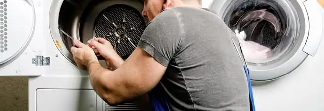 Dryer repair technician fixing a clothes dryer drum in Baton Rouge, LA