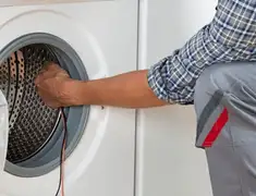 Dryer repair technician diagnosing and servicing a clothes dryer in Baton Rouge, LA