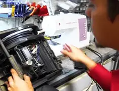 Vacuum repair technician servicing internal components on a workbench in Baton Rouge, LA