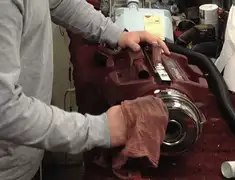 Vacuum repair technician cleaning and servicing a vacuum motor in Baton Rouge, LA