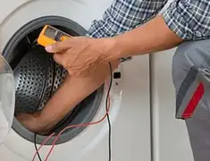 Washing machine repair technician testing a front-load washer with diagnostic tools in Baton Rouge, LA